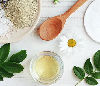 natural ingredients mint daisy and wooden spoon